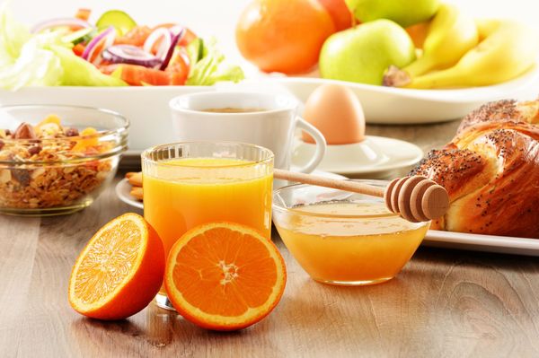 Breakfast including coffee, bread, honey, orange juice, muesli and fruits.jpg